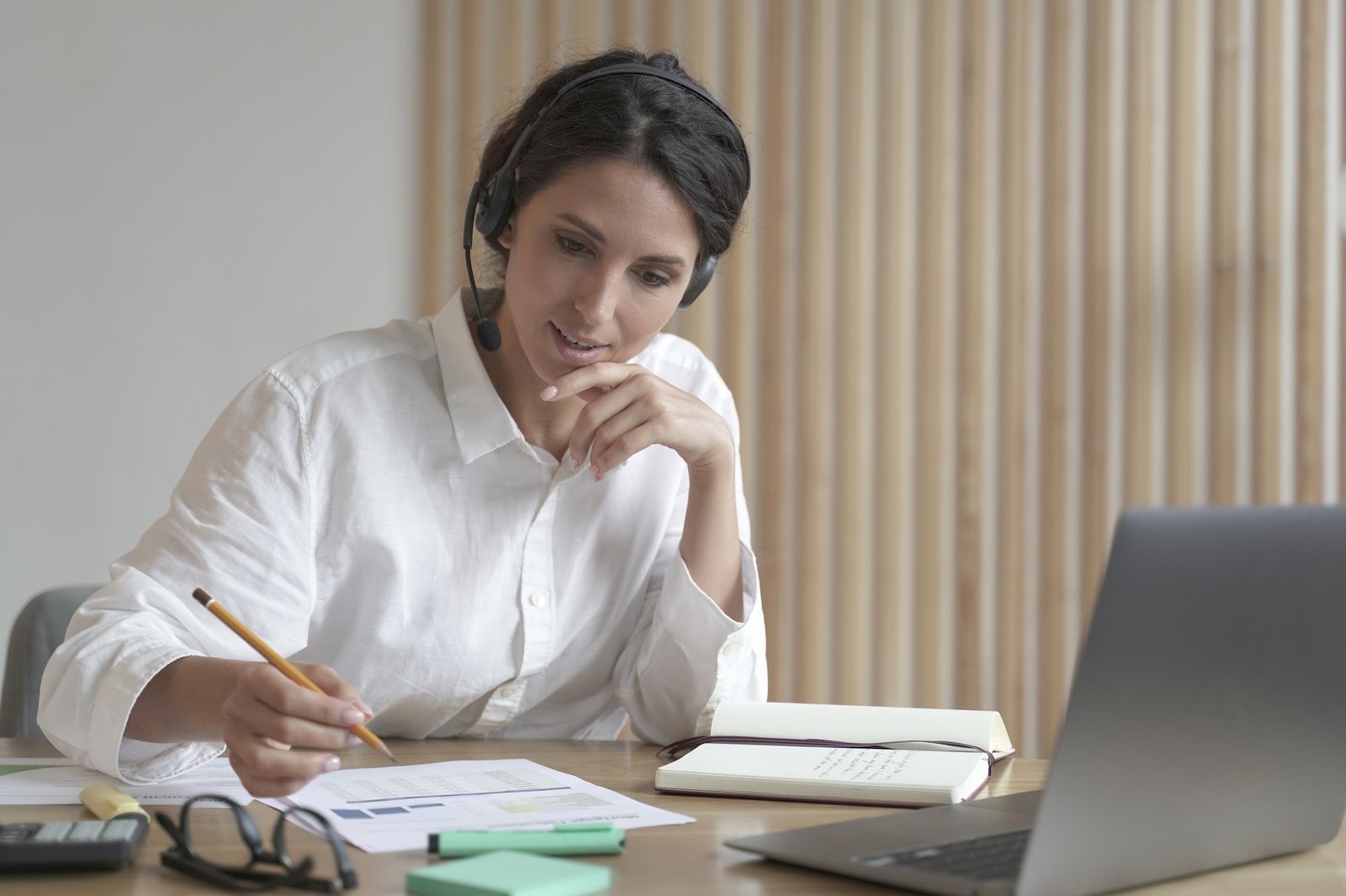 young-professional-female-business-consultant-in-headset-talking-with-client-online-in-office.jpg